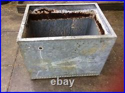 Galvanised riveted vintage water tank could be used as planter or water feature